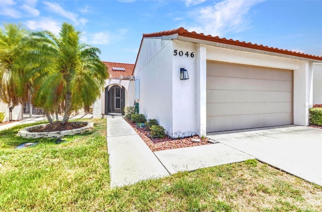 5046 San Rocco Ct, Punta Gorda, FL 33950 - mediterranean / spanish-style house featuring a tile roof, an attached garage, and stucco siding