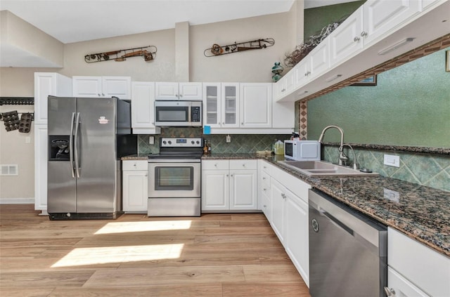 5046 San Rocco Ct, Punta Gorda, FL 33950 - kitchen featuring appliances with stainless steel finishes, a sink, light wood-style floors, white cabinets, and backsplash
