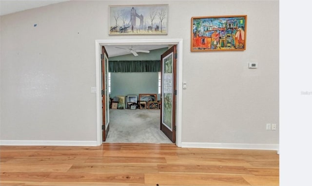 5046 San Rocco Ct, Punta Gorda, FL 33950 - hallway featuring lofted ceiling, wood finished floors, and baseboards
