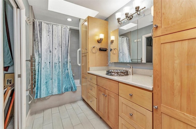 5046 San Rocco Ct, Punta Gorda, FL 33950 - full bathroom with vanity, shower / bath combo with shower curtain, a skylight, tile patterned flooring, and recessed lighting