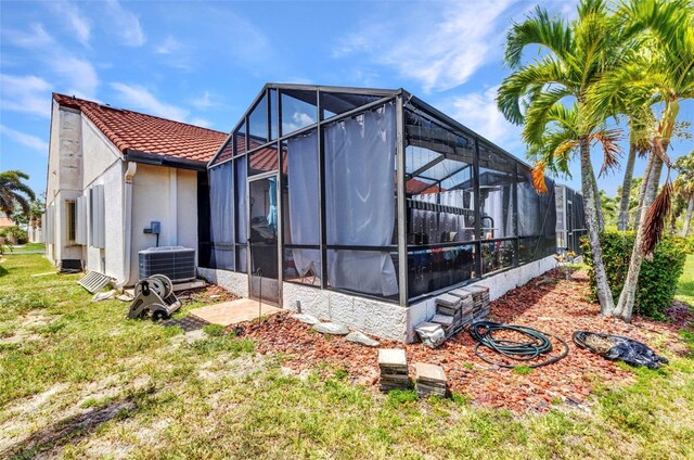 5046 San Rocco Ct, Punta Gorda, FL 33950 - rear view of house featuring central air condition unit, a tile roof, stucco siding, a yard, and a lanai