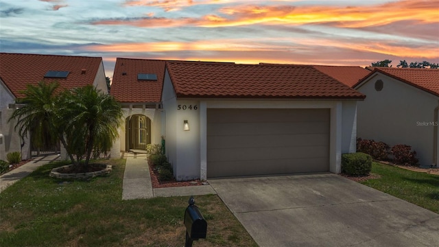 5046 San Rocco Ct, Punta Gorda, FL 33950 - mediterranean / spanish home with a tiled roof, stucco siding, a garage, and driveway