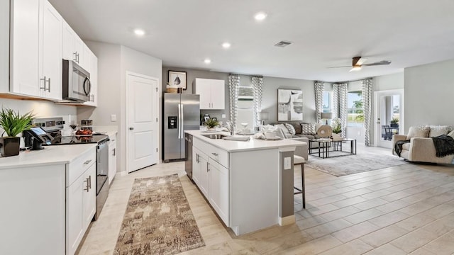 4967 Tuscola Blvd, North Port, FL 34287 - kitchen with stainless steel appliances, open floor plan, a kitchen bar, a sink, and recessed lighting