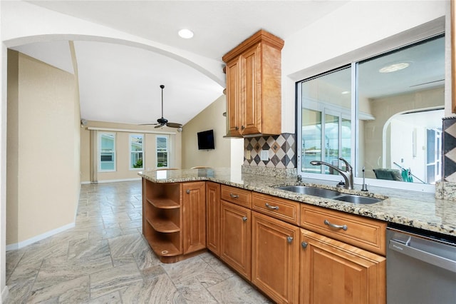 211 E Tarpon Blvd NW, Port Charlotte, FL 33952 - kitchen featuring stainless steel dishwasher, a sink, vaulted ceiling, brown cabinets, and baseboards
