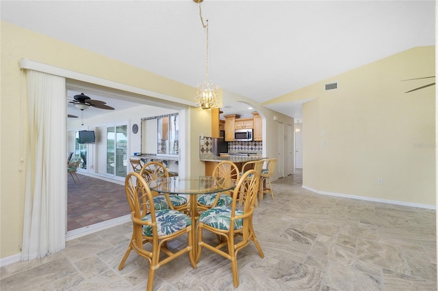 211 E Tarpon Blvd NW, Port Charlotte, FL 33952 - dining area with a ceiling fan, arched walkways, lofted ceiling, baseboards, and a chandelier