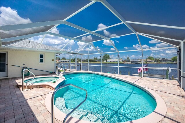 211 E Tarpon Blvd NW, Port Charlotte, FL 33952 - view of swimming pool with a water view, a patio, a lanai, and a pool with connected hot tub
