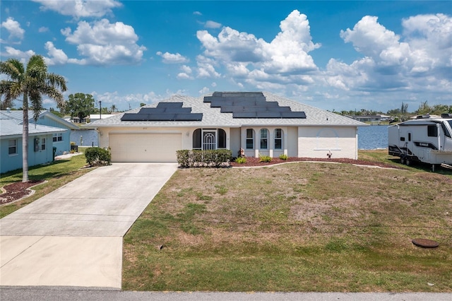 211 E Tarpon Blvd NW, Port Charlotte, FL 33952 - view of front of home featuring a front yard, concrete driveway, a garage, and solar panels