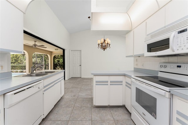 18111 Lake Worth Blvd, Port Charlotte, FL 33948 - kitchen featuring white appliances, a peninsula, a sink, backsplash, and white cabinetry