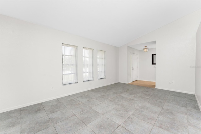 18111 Lake Worth Blvd, Port Charlotte, FL 33948 - unfurnished room featuring vaulted ceiling, light tile patterned flooring, a chandelier, and baseboards