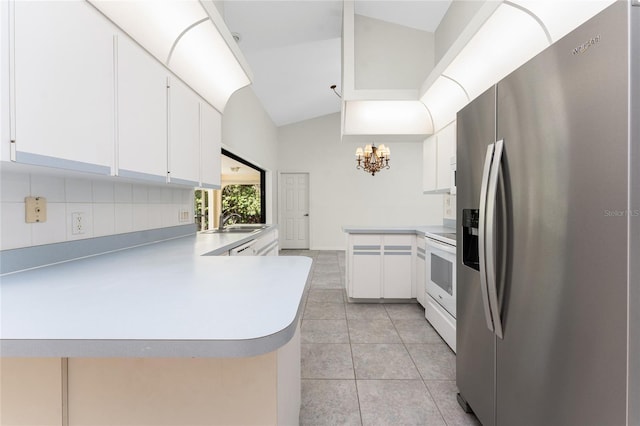 18111 Lake Worth Blvd, Port Charlotte, FL 33948 - kitchen with stainless steel refrigerator with ice dispenser, a peninsula, a chandelier, white electric stove, and vaulted ceiling