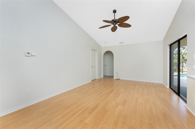 18111 Lake Worth Blvd, Port Charlotte, FL 33948 - empty room with high vaulted ceiling, arched walkways, light wood-style floors, a ceiling fan, and baseboards