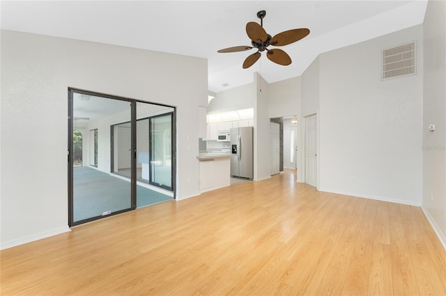 18111 Lake Worth Blvd, Port Charlotte, FL 33948 - unfurnished living room featuring a ceiling fan, light wood-type flooring, high vaulted ceiling, and baseboards