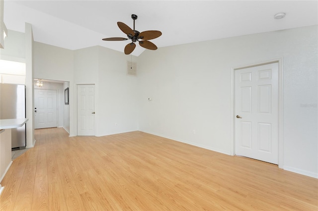 18111 Lake Worth Blvd, Port Charlotte, FL 33948 - unfurnished living room with ceiling fan, light wood finished floors, lofted ceiling, and baseboards