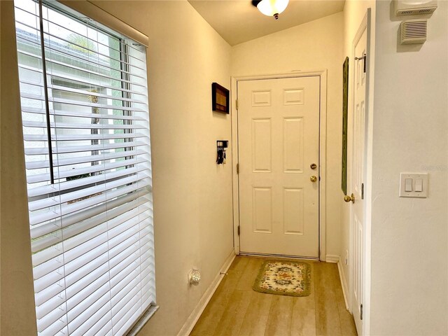 13170 SW Pembroke Cir N, Lake Suzy, FL 34269 - doorway with plenty of natural light, light wood-type flooring, and baseboards