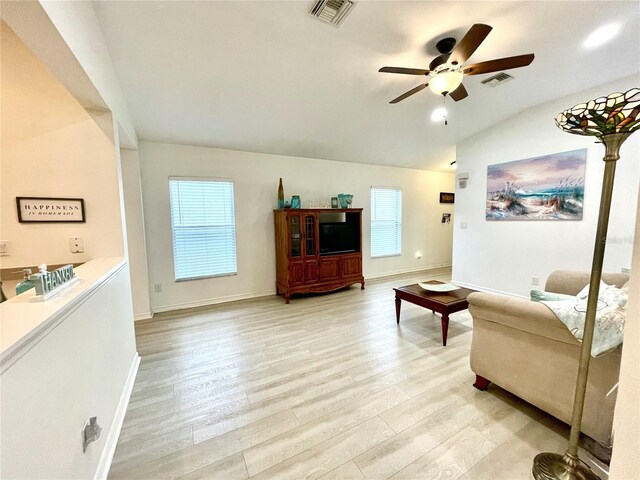 13170 SW Pembroke Cir N, Lake Suzy, FL 34269 - living room with vaulted ceiling, a ceiling fan, light wood finished floors, and baseboards