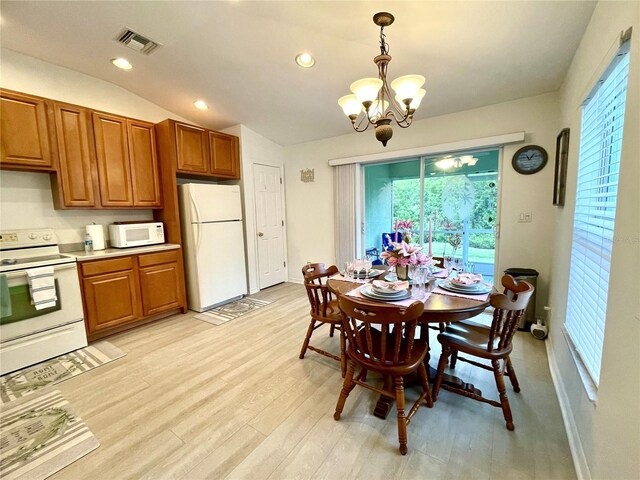 13170 SW Pembroke Cir N, Lake Suzy, FL 34269 - dining space with a chandelier, healthy amount of natural light, light wood-type flooring, vaulted ceiling, and recessed lighting