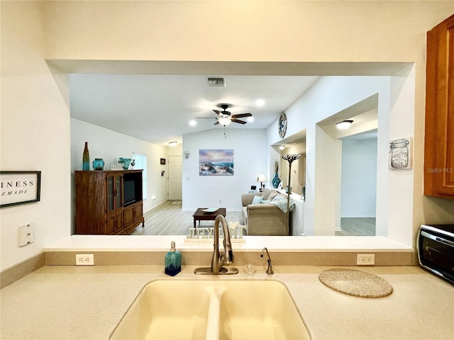 13170 SW Pembroke Cir N, Lake Suzy, FL 34269 - kitchen featuring a sink, ceiling fan, light countertops, vaulted ceiling, and open floor plan