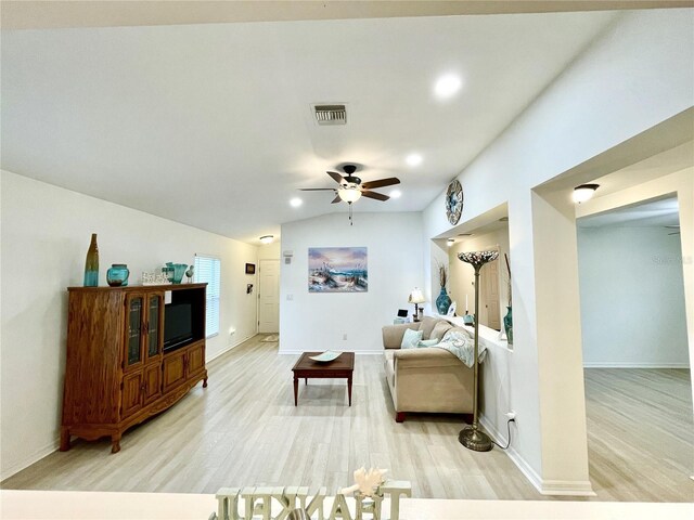 13170 SW Pembroke Cir N, Lake Suzy, FL 34269 - living room with light wood-style flooring, ceiling fan, baseboards, lofted ceiling, and recessed lighting