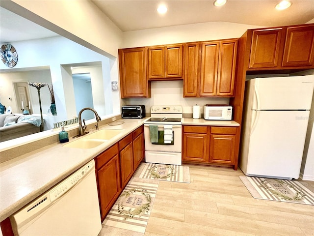 13170 SW Pembroke Cir N, Lake Suzy, FL 34269 - kitchen featuring white appliances, a sink, light countertops, recessed lighting, and light wood-type flooring