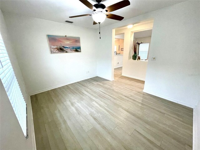 13170 SW Pembroke Cir N, Lake Suzy, FL 34269 - empty room featuring a ceiling fan, wood finished floors, and baseboards