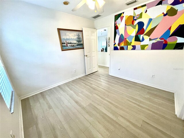 13170 SW Pembroke Cir N, Lake Suzy, FL 34269 - spare room with wood finished floors, baseboards, and a ceiling fan