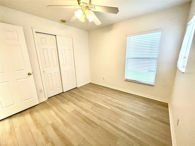 13170 SW Pembroke Cir N, Lake Suzy, FL 34269 - unfurnished bedroom featuring light wood-style floors, baseboards, a closet, and a ceiling fan