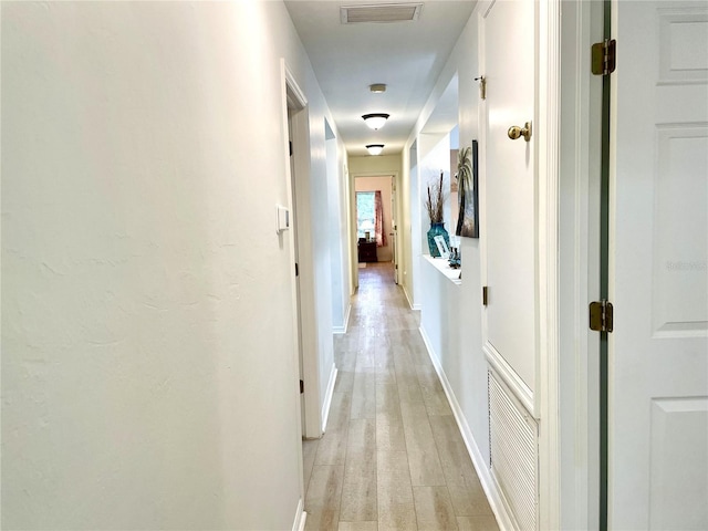13170 SW Pembroke Cir N, Lake Suzy, FL 34269 - hallway featuring light wood finished floors and baseboards