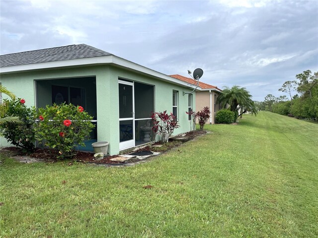 13170 SW Pembroke Cir N, Lake Suzy, FL 34269 - view of green lawn featuring a sunroom
