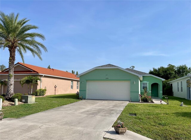 13170 SW Pembroke Cir N, Lake Suzy, FL 34269 - ranch-style home with a garage, a front lawn, concrete driveway, and stucco siding