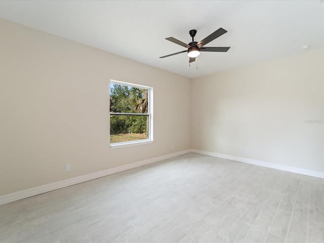 unfurnished room featuring ceiling fan, baseboards, and light wood-type flooring