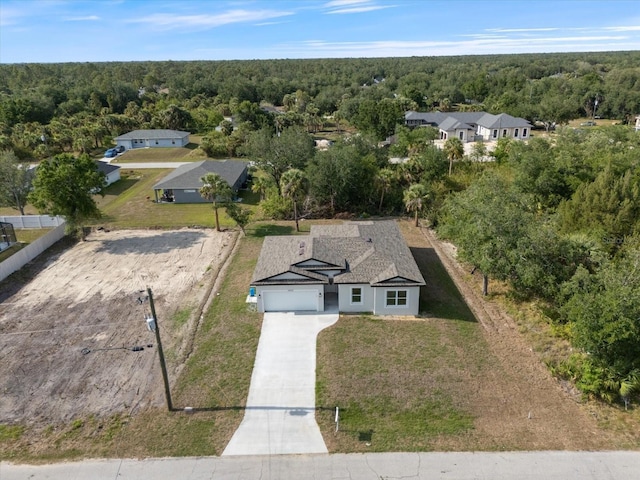 view from above of property with a heavily wooded area