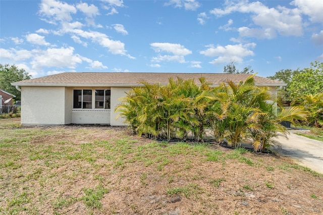 4282 Pocatella Ave, North Port, FL 34287 - view of side of property with stucco siding and a lawn