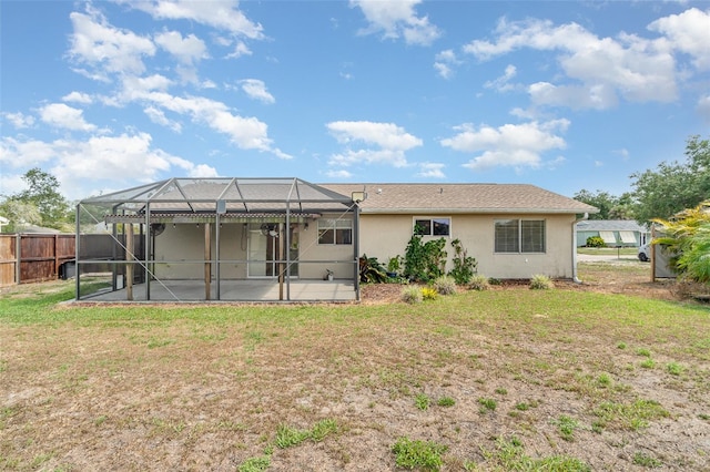 4282 Pocatella Ave, North Port, FL 34287 - rear view of house featuring stucco siding, a patio, and glass enclosure