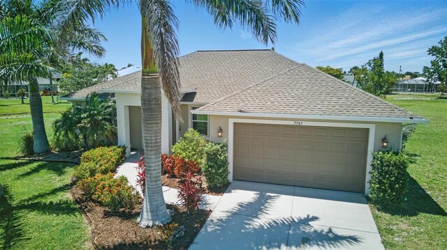 7505 Carissa, Punta Gorda, FL 33955 - view of front facade featuring a shingled roof, stucco siding, a garage, and a front yard