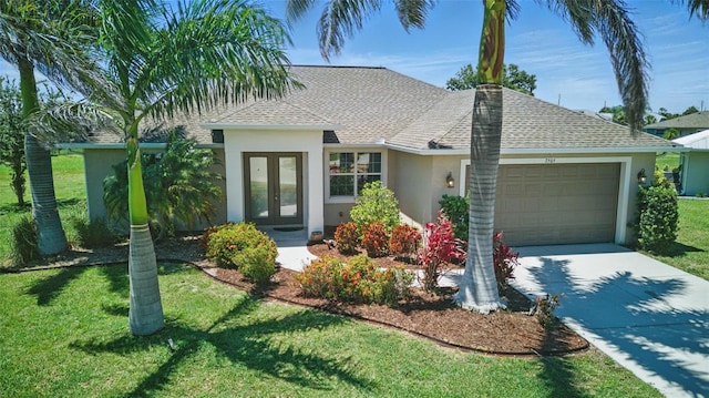 7505 Carissa, Punta Gorda, FL 33955 - view of front of house with french doors, stucco siding, an attached garage, concrete driveway, and a front yard