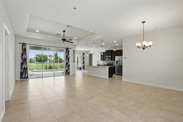 7505 Carissa, Punta Gorda, FL 33955 - unfurnished living room featuring a chandelier, a raised ceiling, a ceiling fan, a sink, and ornamental molding