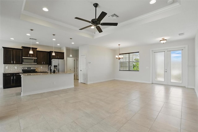 7505 Carissa, Punta Gorda, FL 33955 - unfurnished living room with a raised ceiling, a chandelier, recessed lighting, a ceiling fan, and ornamental molding