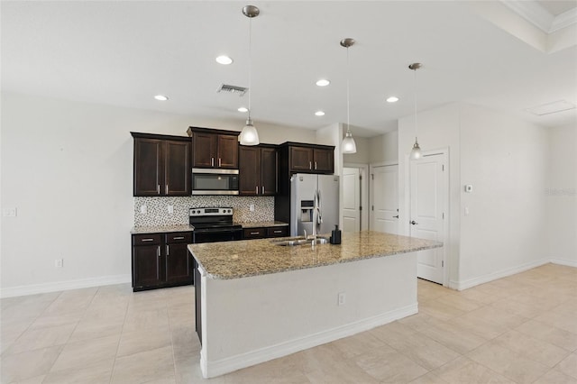 7505 Carissa, Punta Gorda, FL 33955 - kitchen with stainless steel appliances, tasteful backsplash, dark brown cabinetry, a center island with sink, and recessed lighting