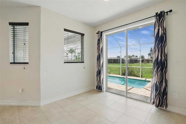 7505 Carissa, Punta Gorda, FL 33955 - spare room with baseboards and light tile patterned floors