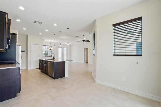 7505 Carissa, Punta Gorda, FL 33955 - kitchen with a ceiling fan, open floor plan, a center island with sink, dishwasher, and baseboards