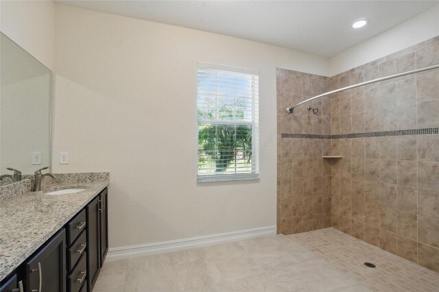 7505 Carissa, Punta Gorda, FL 33955 - full bathroom with vanity, a tile shower, baseboards, and recessed lighting