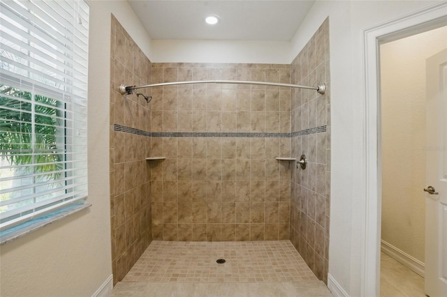 7505 Carissa, Punta Gorda, FL 33955 - bathroom featuring plenty of natural light, a tile shower, and baseboards