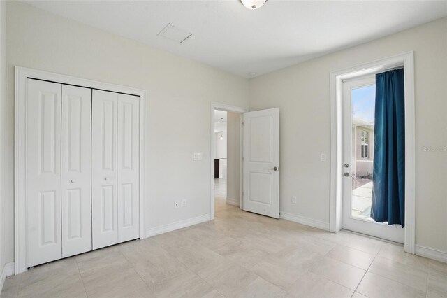 7505 Carissa, Punta Gorda, FL 33955 - unfurnished bedroom with multiple windows, a closet, and baseboards