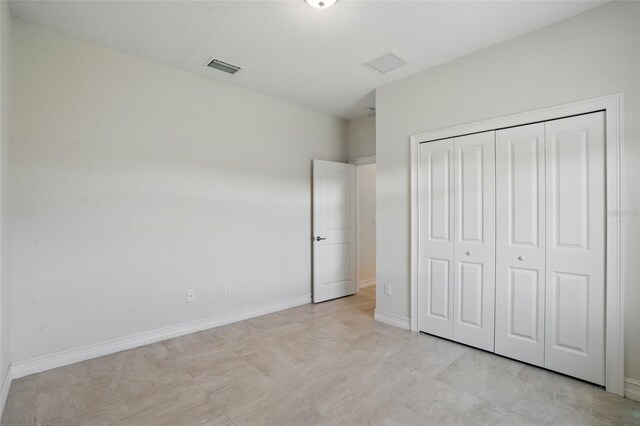 7505 Carissa, Punta Gorda, FL 33955 - unfurnished bedroom featuring a closet and baseboards