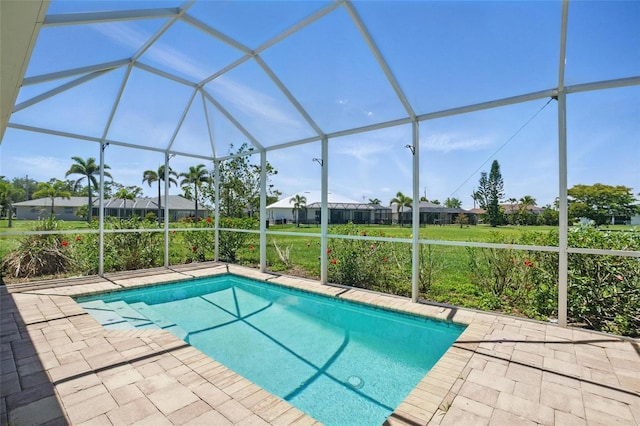 7505 Carissa, Punta Gorda, FL 33955 - outdoor pool featuring glass enclosure, a patio, and a residential view
