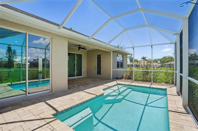 7505 Carissa, Punta Gorda, FL 33955 - outdoor pool featuring a patio, glass enclosure, and a ceiling fan