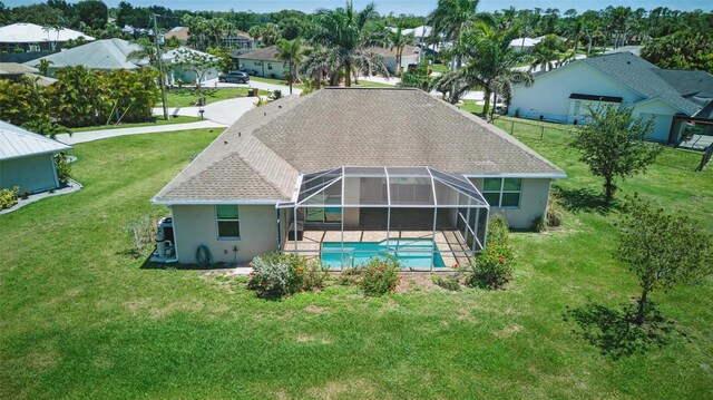 7505 Carissa, Punta Gorda, FL 33955 - rear view of house with an outdoor pool, stucco siding, a yard, a patio area, and glass enclosure