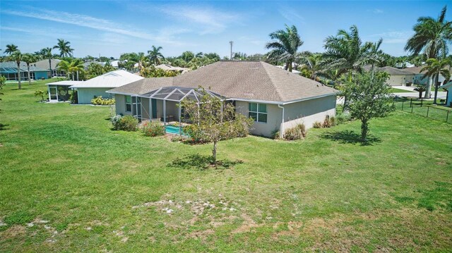 7505 Carissa, Punta Gorda, FL 33955 - back of house featuring glass enclosure and stucco siding