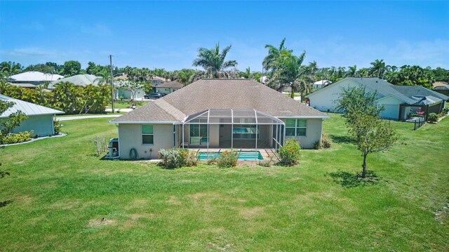 7505 Carissa, Punta Gorda, FL 33955 - back of property with a yard, an outdoor pool, glass enclosure, and stucco siding