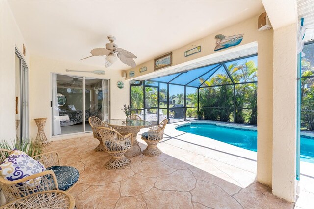 279 Mariner Ln, Rotonda West, FL 33947 - swimming pool featuring a patio area, ceiling fan, glass enclosure, and outdoor dining area
